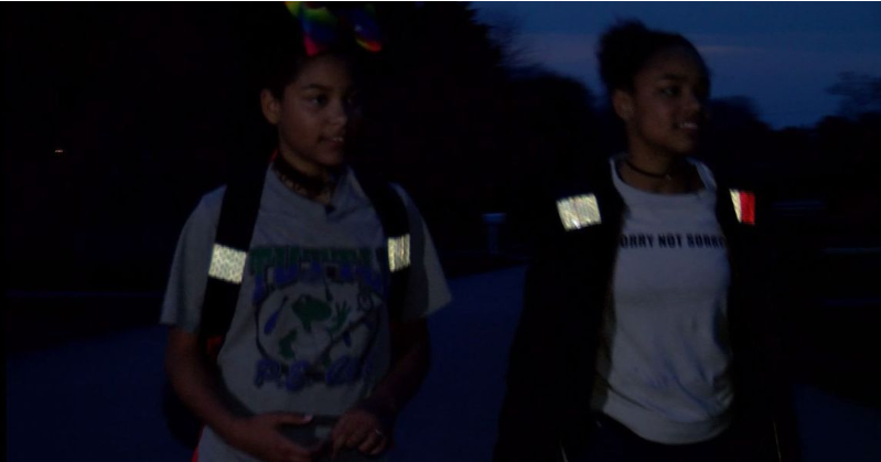 Students use reflective tape on backpacks to stay safe at bus stops